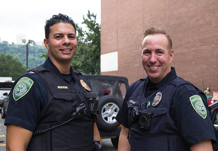 Point Park police officers Lt. Nicholas Black and Alex Lee show off their body cameras on Move In Day, which they have worn since Aug 1. The newest requirement for officers is to carry a heroin OD antidote, Narcan. 