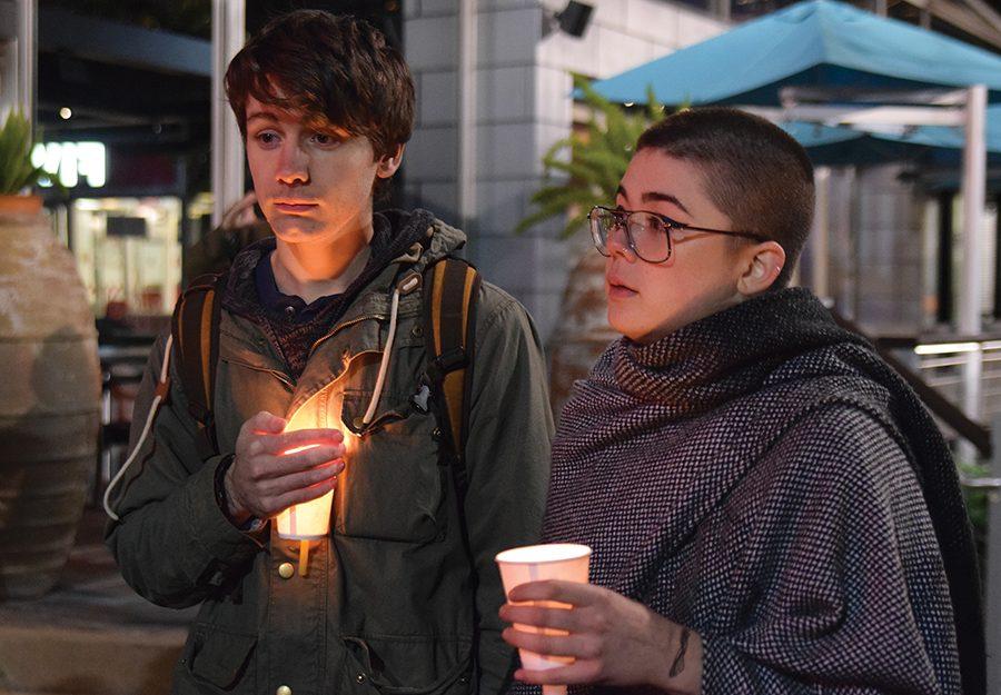 Chris Beaulieu, junior SAEM major, and Selena Hurst, junior photography major, stand in silence in preparation for the protest vigil that was held in Market Square on Wednesday night.
