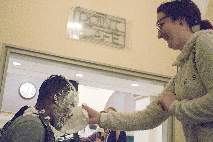 Anntonietta Borzacchiello, journalism major, throws a pie at USG President Blaine King at “Pie the President” as part of WPPJ’s Rockathon on Nov. 1. All benefits went to the Early Learning Institute.