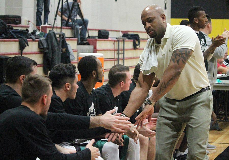Assistant coach Wayne Copeland high fives his players on the sidelines during their game against WVU Tech on December 3. 