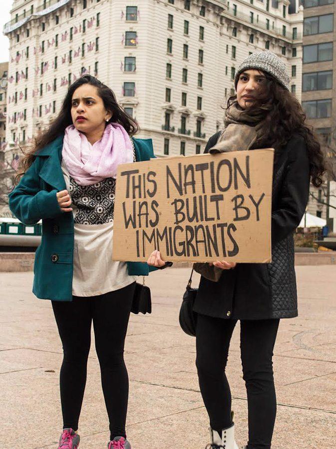 Two young women stood together to protest alongside many others agaisnt the new President, Jan 20 2017.  Photo by Megan Bixler