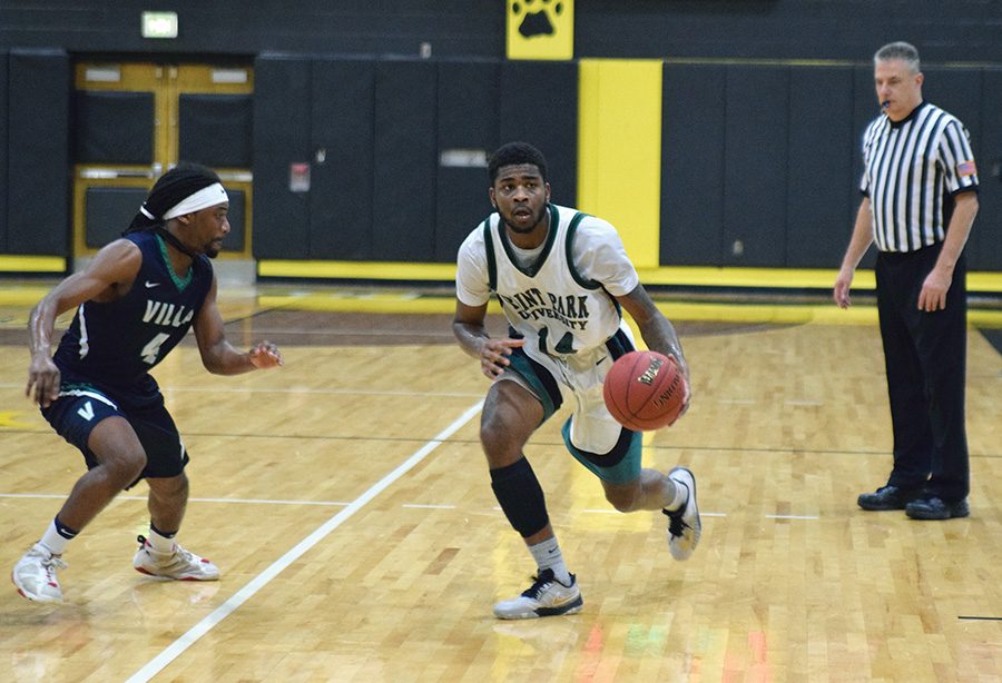 Sophomore, Asim Pleas, makes his way down the court during their game against Villa Maria last Wednesday. The Pioneers won, 87-85.
