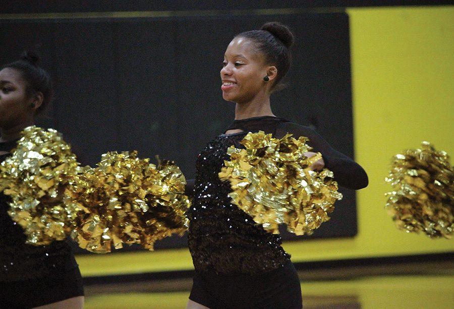 Junior dance team captain Amber Mole cheers at a Dec. 12 basketball game at CCAC South. 