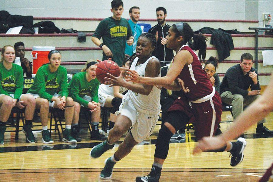 Junior guard Shaniya Rivers drives against No. 21 IU East Friday in the Pioneers’ 73-50 loss. Point Park is 7-7 in RSC play.