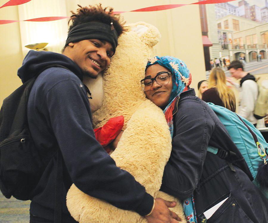 Cameron Miller, sophomore business major, and Princess Winder, freshman stage management major, hug a stuffed bear Miller won in a raffle at the Candy and Kisses event hosted by CAB on Valentine’s Day.