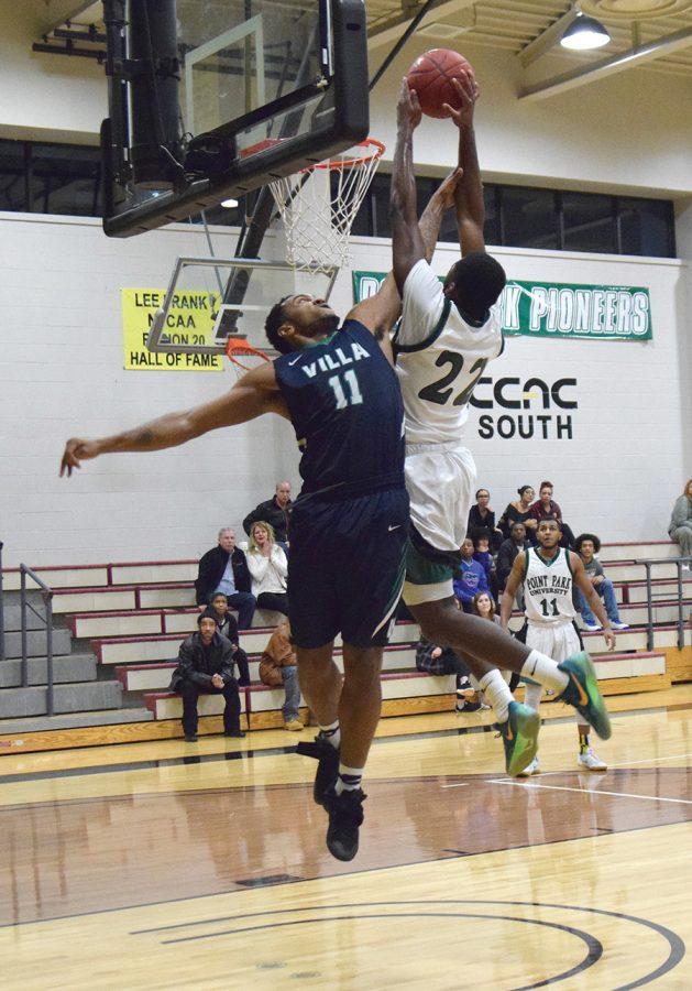 Senior, Jaylen Mann, attempts to make a basket against Villa Maria’s, Gerald Bibbs, on January 25. The Pioneers won, 87-85.
