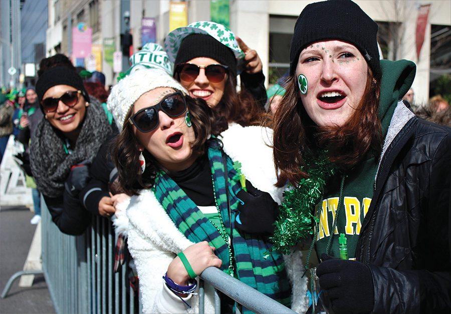 Dance majors Noel Knostman, Kelsey Fusch, Marina Damon and Emma Page watch Pittsburgh’s annual St. Patrick’s Day parade outside Lawrence Hall. Students and spectators lined the Boulevard of the Allies Saturday morning for the festivites despite frigid temperatures. 