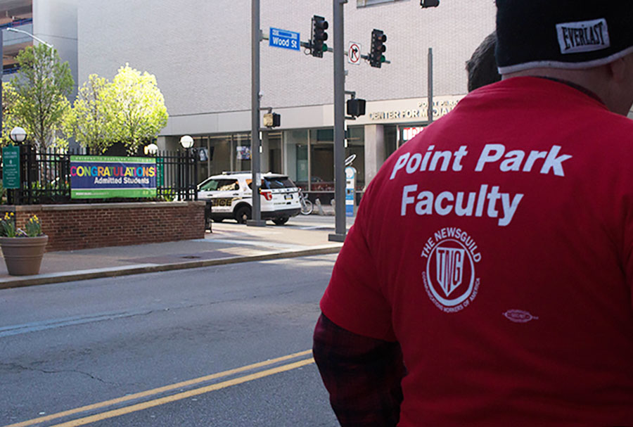 Full time faculty members demonstrated outside Lawrence Hall on admitted students day Saturday.