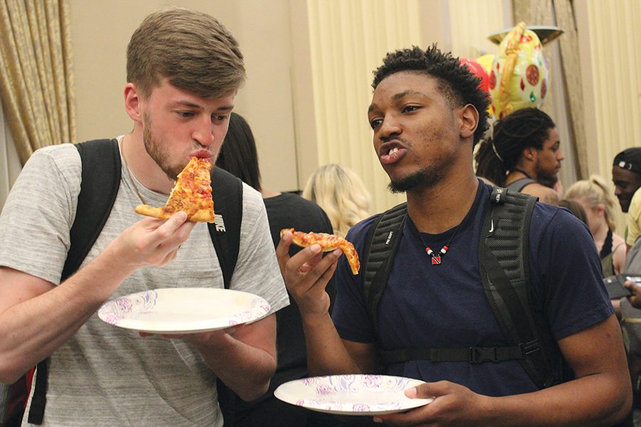 Peter King, a freshman biology major, and Greg Nolf, a freshman secondary education major, enjoy a slice of Giovanni’s cheese pizza at Pizza Palooza sponsored by Campus Activities Board (CAB). They were waiting outside the door along with the crowd 10 minutes prior to the event. CAB’s executive director Colten Gill tweeted that the event gave away 1,896 slices of pizza. 