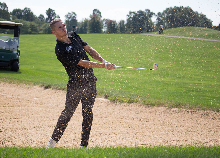 Junior Rafael Perez takes a chip shot out of the bunker at the Carnegie Fall Shootout at The Links at Spring Church on Sept. 16. The Pioneers finished sixth out of 10 schools.
