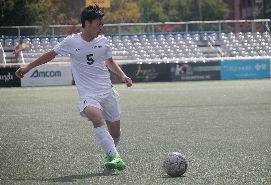 Sophomore defender, Yuki Takeda, prepares to pass the ball to a teammate during a home game on Sept. 9 against Siena Heights. The Pioneers recorded their first win of the season with the 2-0 victory against the Saints.