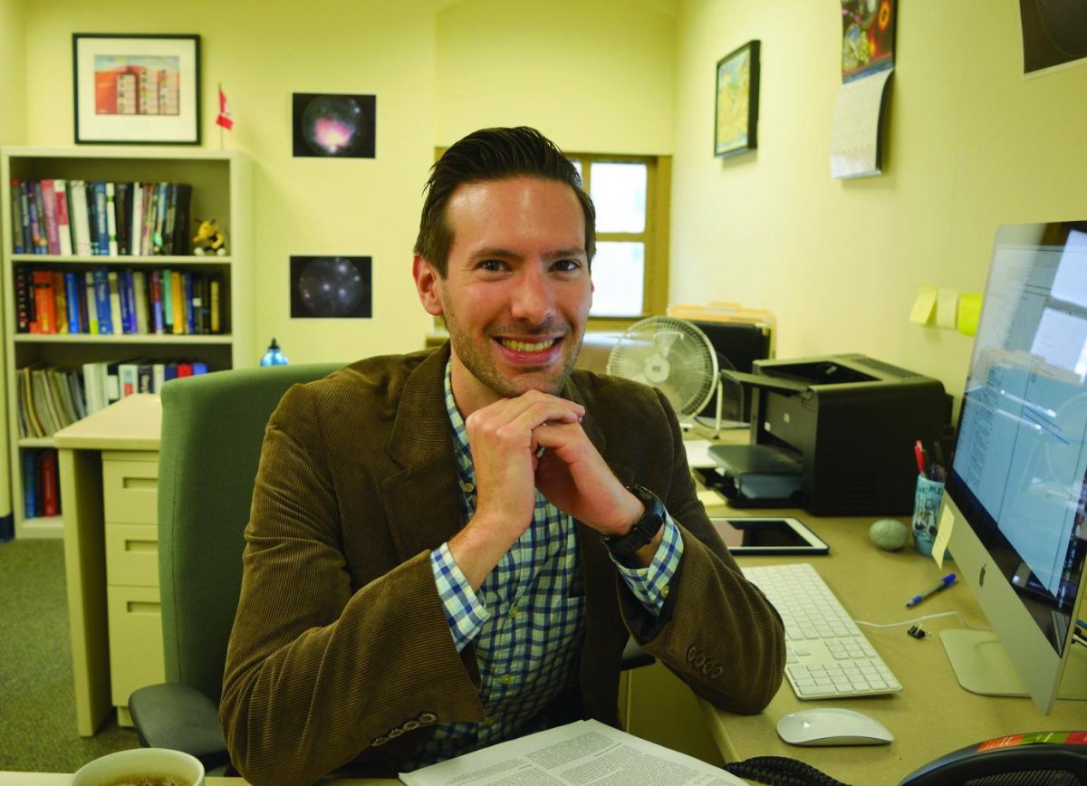 Brendan Mullan sits in his office in the Honors department in Lawrence Hall.