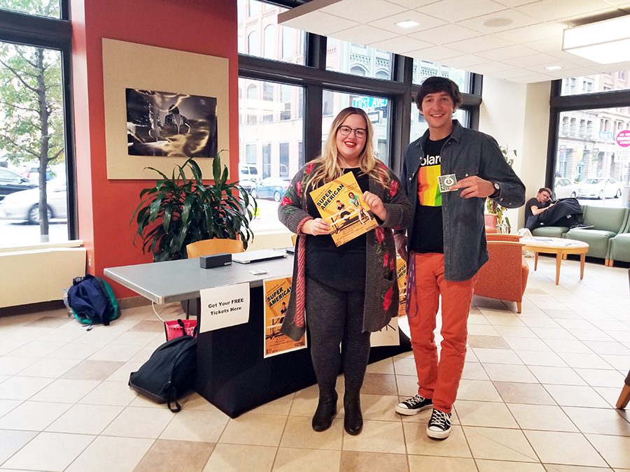 Kylie Koch and Chase Barron give out tickets in the West Penn lobby Thursday for an upcoming show at the Pittsburgh Playhouse featuring Super American, Young Lungs, and Chase and the Barons.