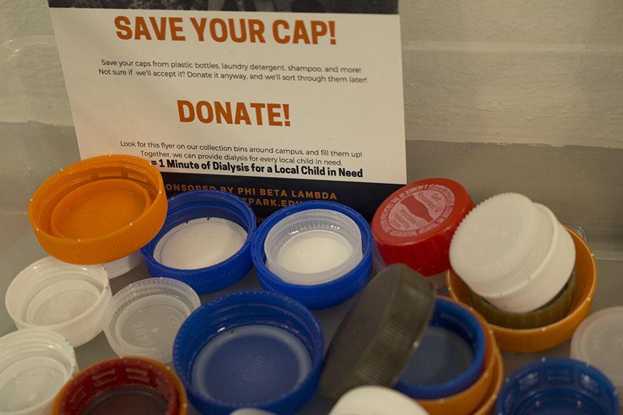 Caps for kids donation bins can commonly be found near recycling bins on campus 