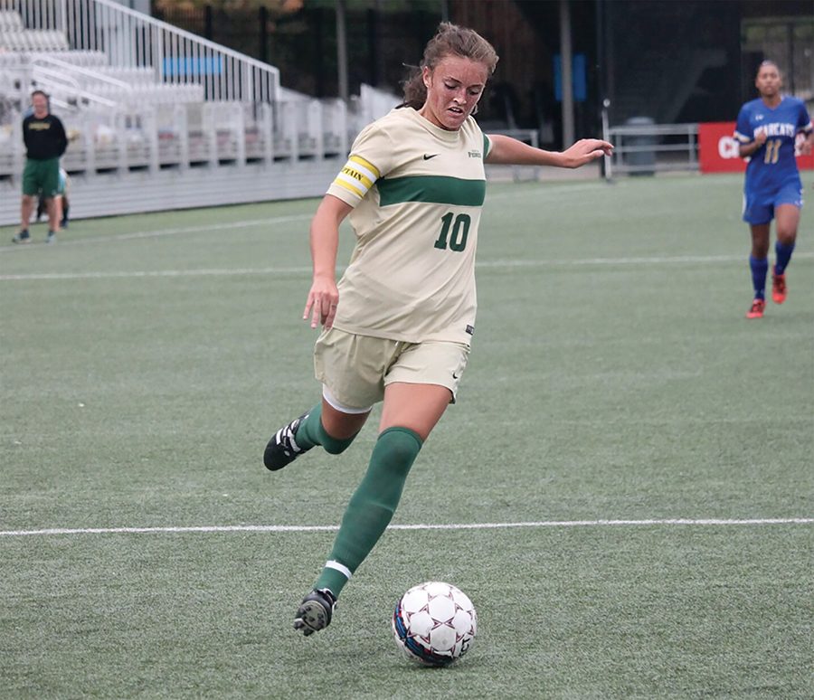 Senior midfielder Izzy Hunter controls the ball up the field. Hunter scored the first goal of the game against OCU last Saturday.