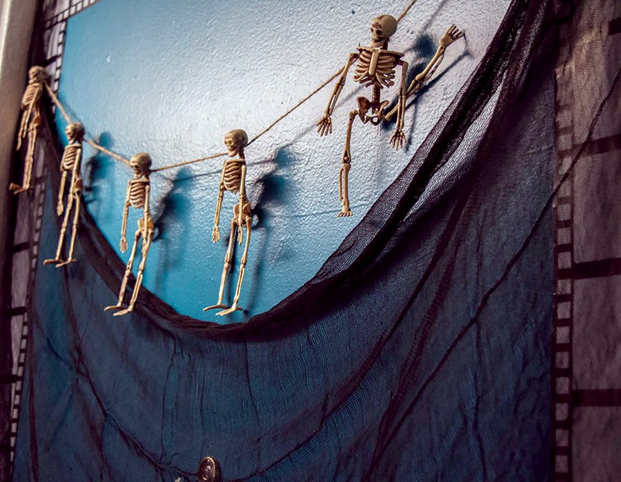 A string of small skeletons hangs from a door on the 16th floor of Lawrence Hall. 