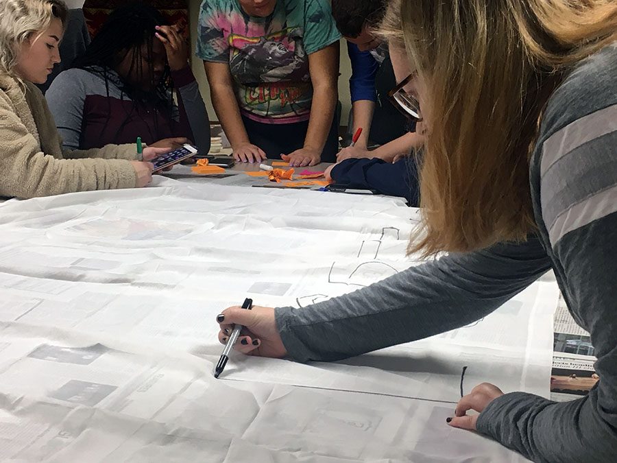 Students met on Nov. 2 to make signs for the silent protest and write on post-its why they are against Ruddy speaking.