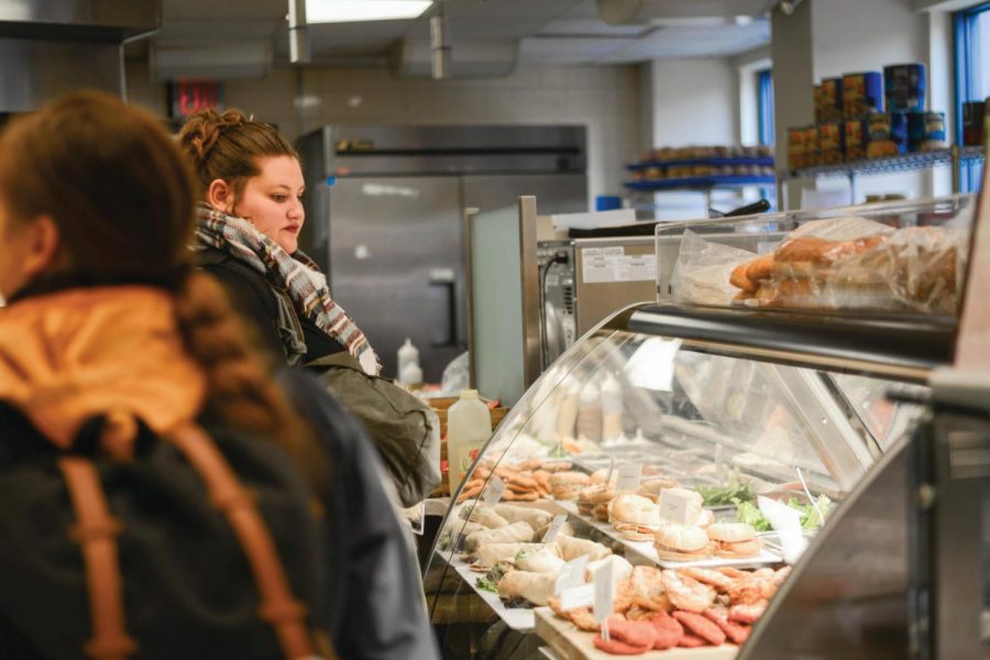 Students line up at the sandwich/wrap station in the Point Cafe, one of the dining options on campus.