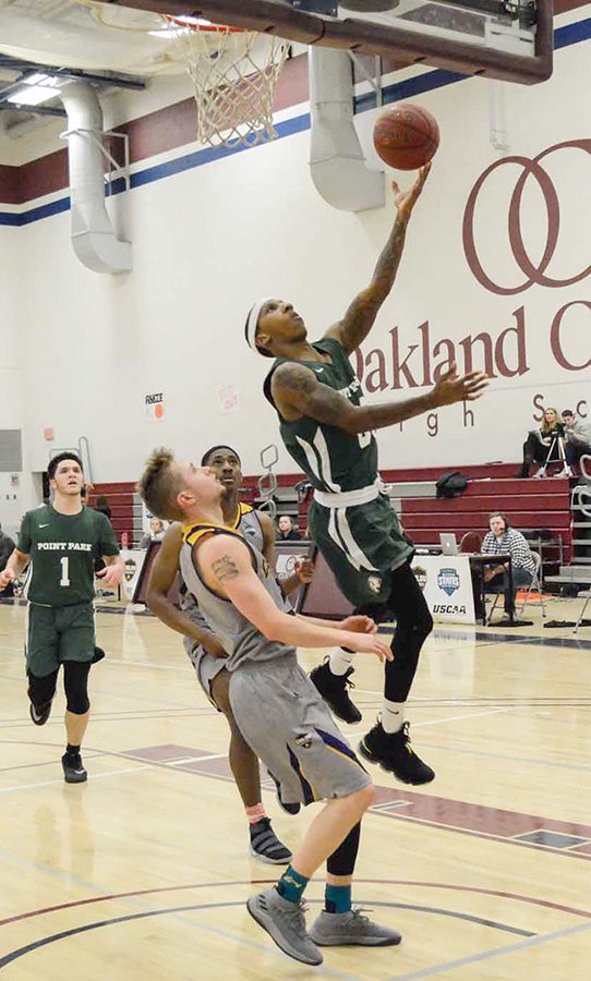 Senior guard Rushan Roberts drives for a layup against Carlow last Tuesday. He recorded new career highs in points (26) and rebounds (11) in the loss.