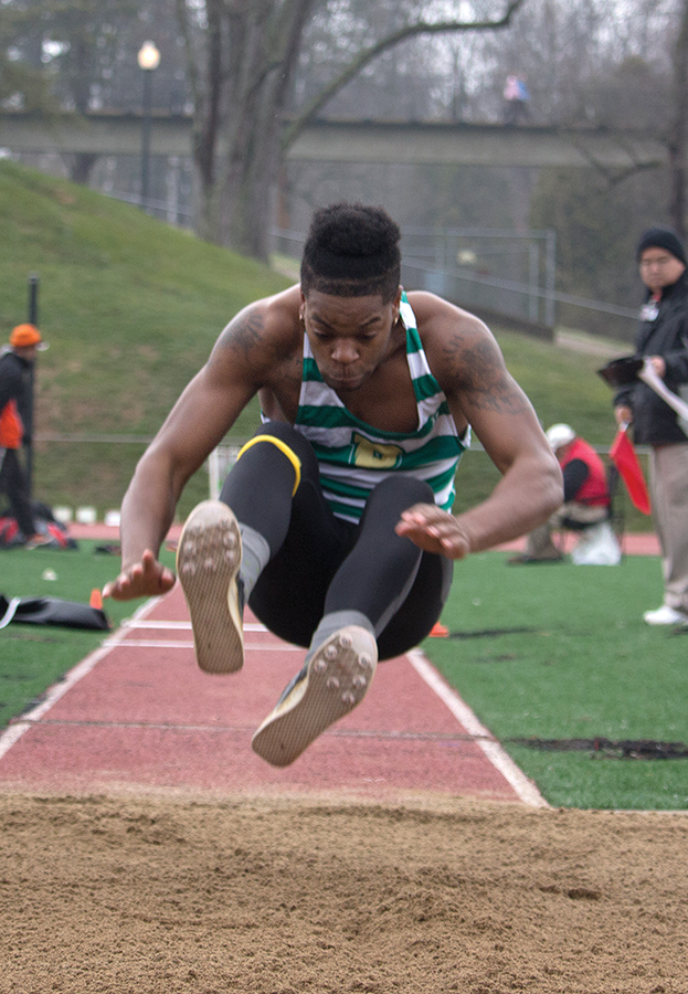 Junior Michael Morris jumps at a meet last season. Morris surpassed his high jump school record with a height measuring 1.99 meters last Saturday.