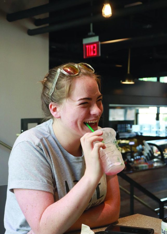 Allison Hritz, sophomore secondary studies major, finishes off a drink at the new coffee shop on campus, Point Perk. 