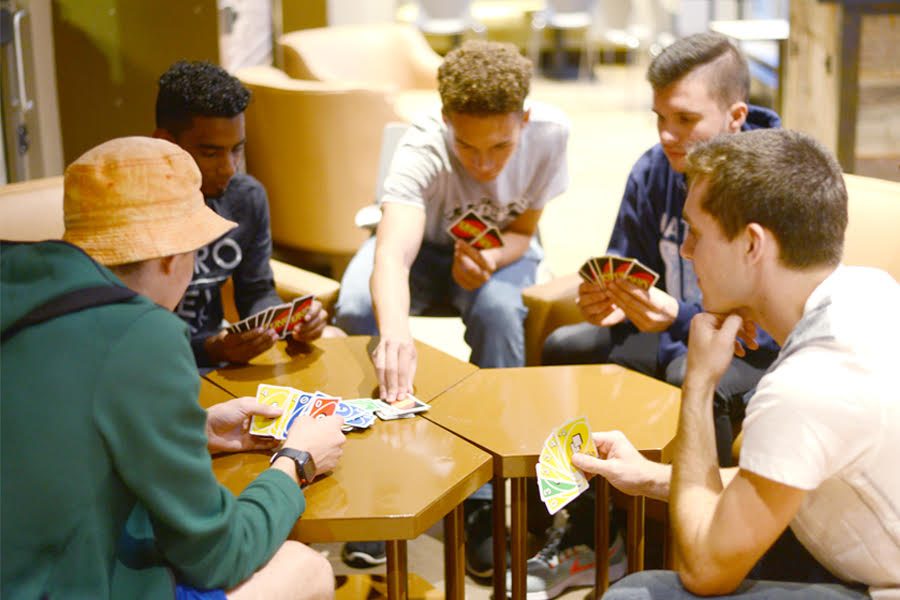 The executive board of the Point Park Uno League plays a game of Uno in campus coffee shop Point Perk.