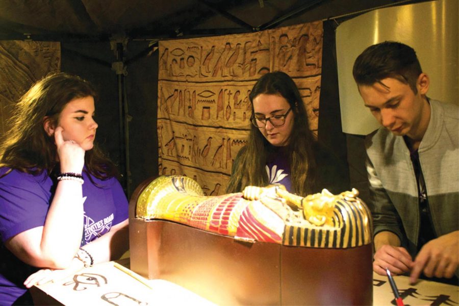 Freshman Emily Porter, sophomore Madeline Rexroad and junior Jake Taylor to try to decipher hieroglyphics in an Ancient Egyptian-themed escape room at CAB’s event Saturday night. 
