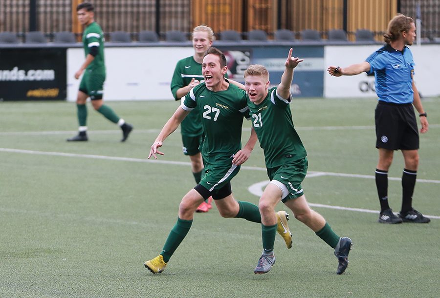 Freshman+Christopher+Ciucanu+%28left%29+celebrates+his+overtime+goal+with+sophomore+Mitchell+Roell+%28right%29+Saturday+at+Highmark+Stadium.+The+mens+soccer+team+defeated+Asbury+1-0+on+their+senior+day.