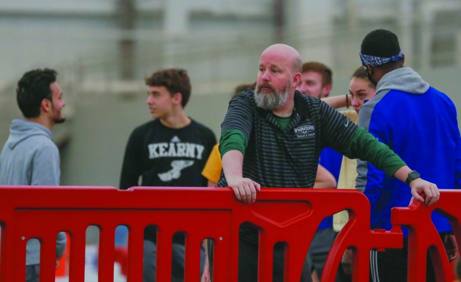 Former head coach of the track and field and cross country teams, Kelly Parsley, stands on the sidelines during a meet earlier this season. Parsley was named Coach of the Year ten times total throughout his tenure with the teams before his termination on Friday.