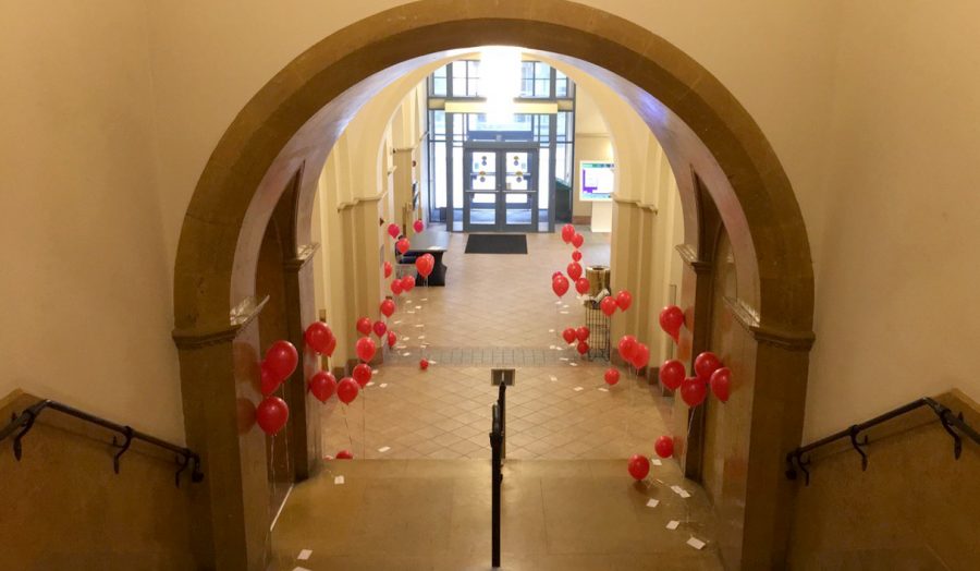The+lobby+of+Lawrence+Hall+was+filled+with+red+balloons+donning+positive+messages+on+a+notecard+attached+to+their+strings.+The+university+Twitter+account+encouraged+students+to+spread+the+love+by+passing+along+the+balloons.