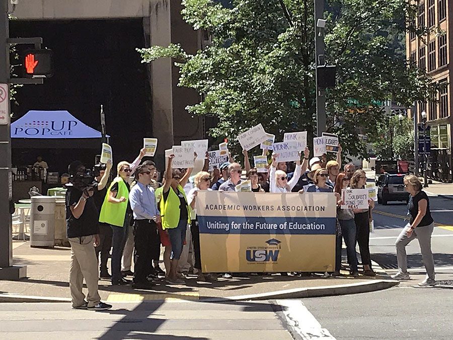 Adjunct faculty protest at the corner of Village Park during move-in on Aug. 19.