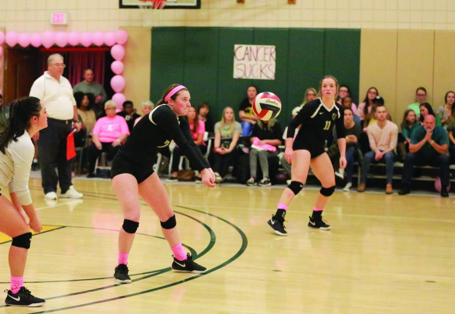 Ashley Castelli, now a sophomore, prepares to pass a ball in the breast cancer awareness match last season in the Student Center.