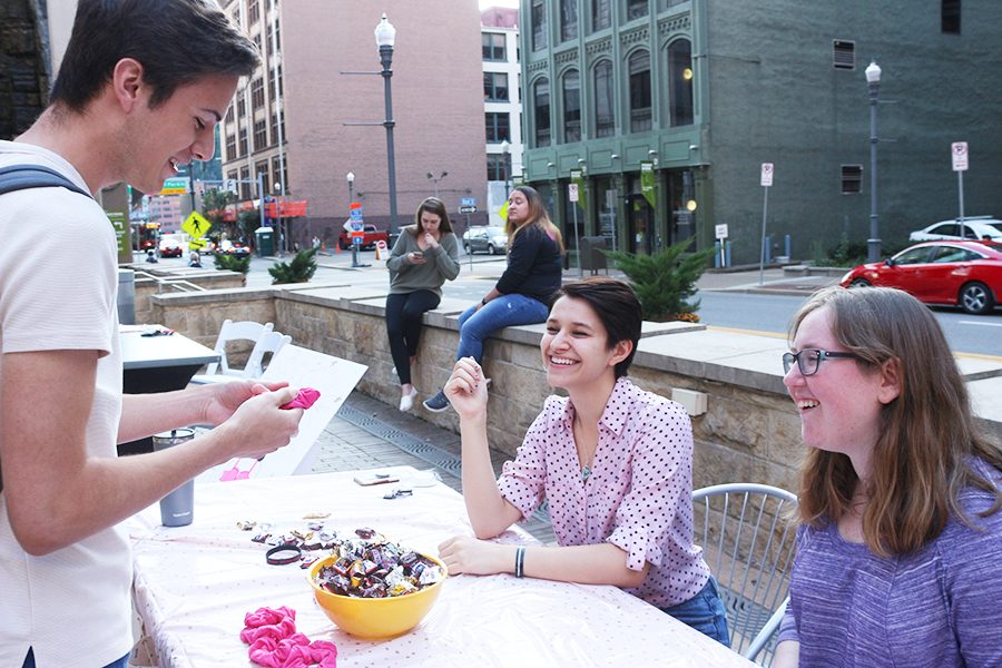 Tyler Levesque (left), Vitoria Garcia (middle) and Sara Buchdahl (right) participate in Pinknic, one of the Honors Student Organization’s month-long Pink Feet events. Proceeds went to the Susan G. Komen Foundation.