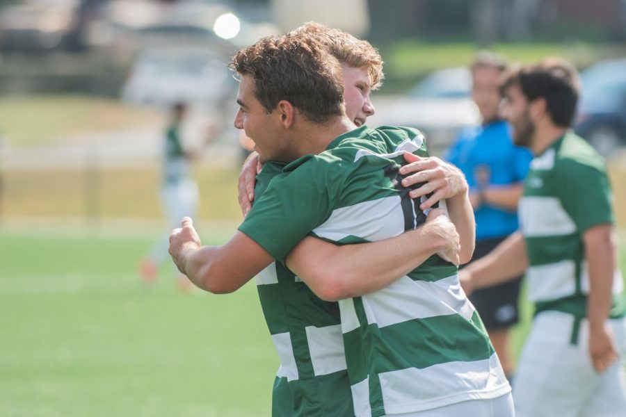 Juniors Mitchell Roell and Geert Bijl celebrate a win with a hug in a game at the Montour Junction Sports Complex. The celebration continued when the team beat the school record for most wins in a season.