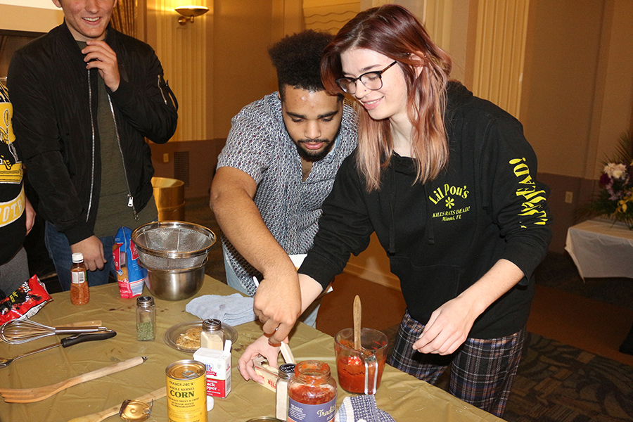 Owen Lewis, left, and Stella Dickinson, right, partook in a cooking competition put on by ADFED and PRSSA on November 19 in the Lawrence Hall Ballroom. They were tasked with preparing a meal
using only ingredients from the Pioneer Pantry.