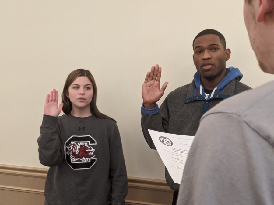 Lillian Hinckley (left) of the School of Arts and Sciences and Chris Blount (right) of COPA are sworn in as senators at Mondays SGA meeting.