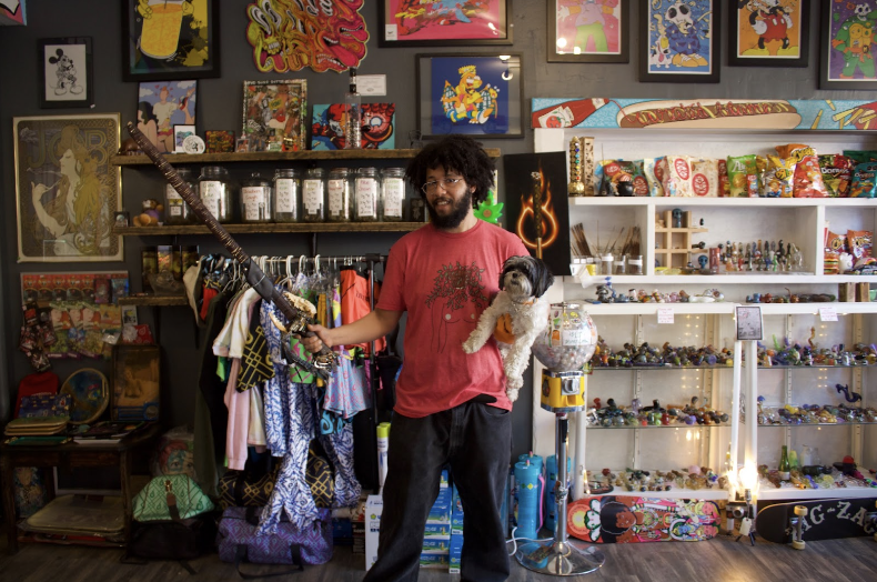 Anthony+%E2%80%9CMo%E2%80%9D+Rabovitz%2C+a+Point+Park+alum%2C+poses+in+his+shop%2C+Curated+Flame+in+Millvale.
