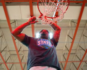 Jalen Stamps cutting down the net after the conference championship victory.