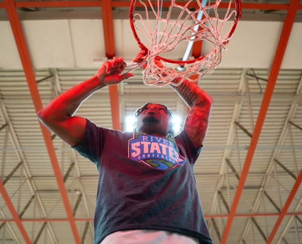 Jalen Stamps cutting down the net after the conference championship victory.