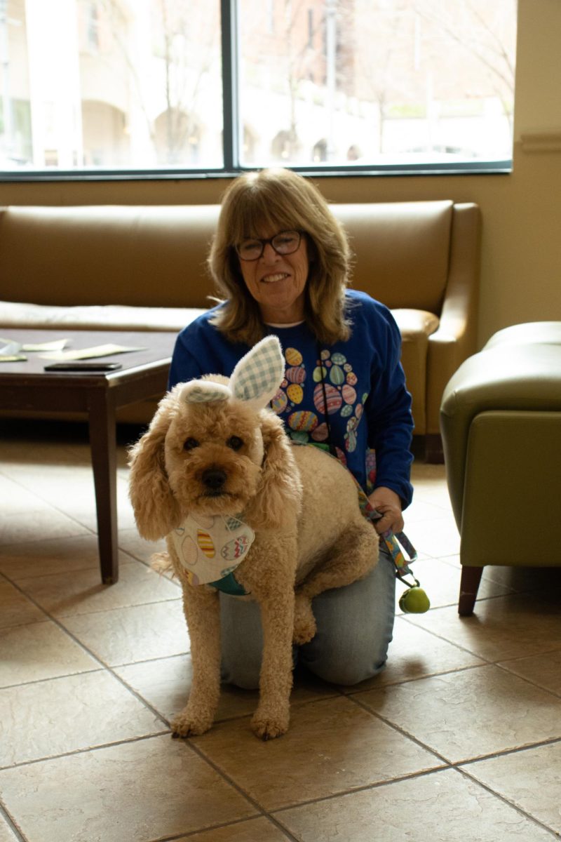 Clancy, who has participated in College Canines previously, stands with his owner Bridget Watson in the Lawrence Hall Lobby. 