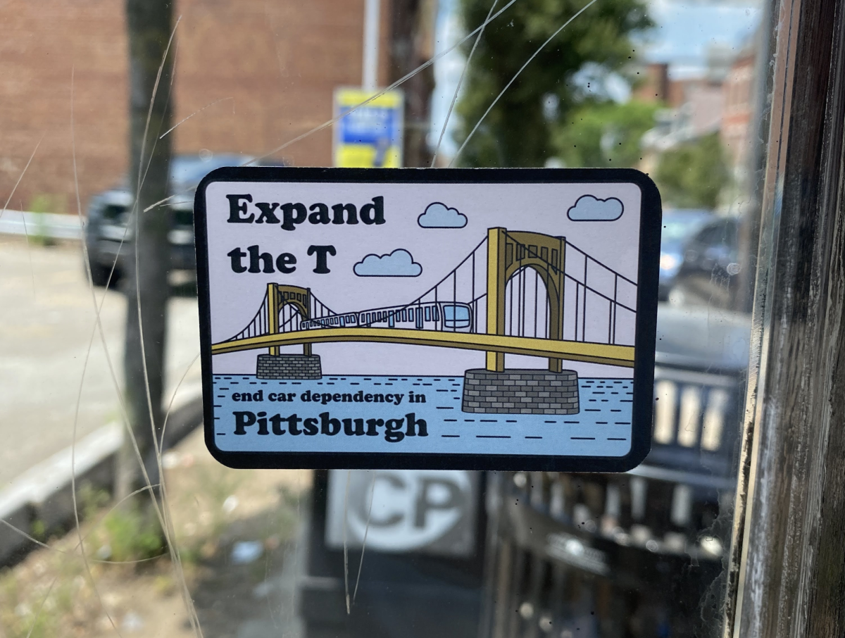 A sticker in a bus shelter calling for expanding the T.