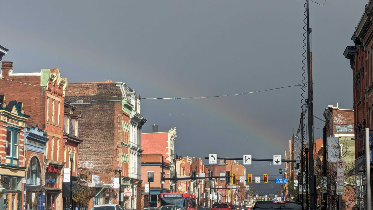A rainbow peaks through the dark and cloudy sky on South 17th Street last Thursday.