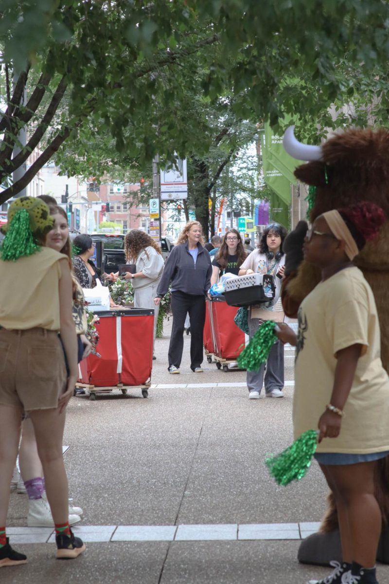 Freshman students push bins while Pioneer Ambassators hype them up during  “Move the Herd.”