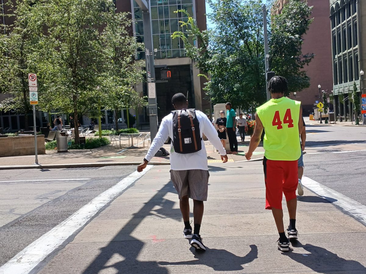 Students who recently returned to campus, cross the Boulevard of the Allies