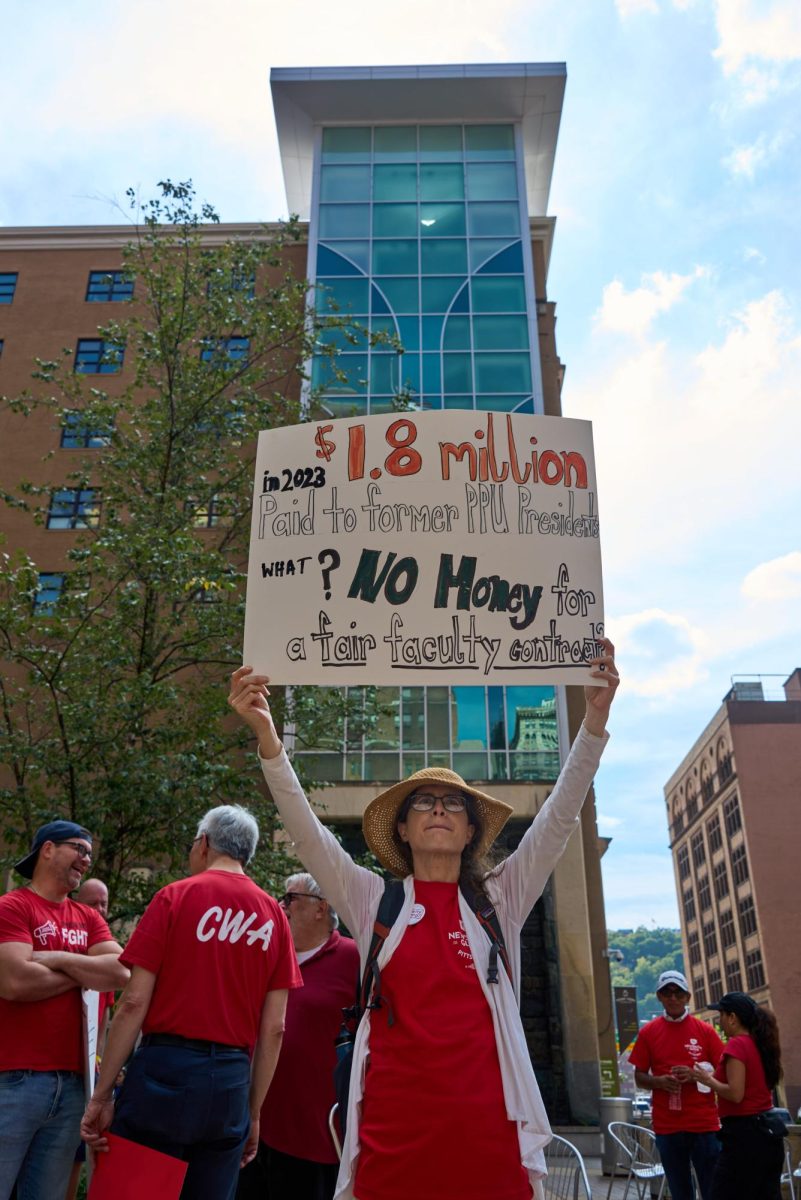 Dressed in bright red shirts, protesters contained within a block on Wood Street spanning Third to Fourth streets, chanted, “What do we want? Contracts! When do we want it? Now!” on Friday.