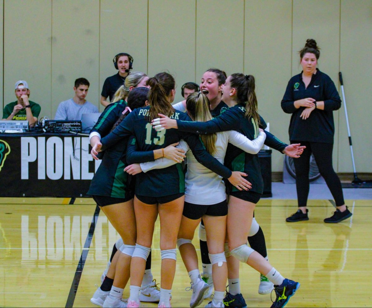 The Pioneer celebrate their win against the Senators in the Student Center on Sept.26.