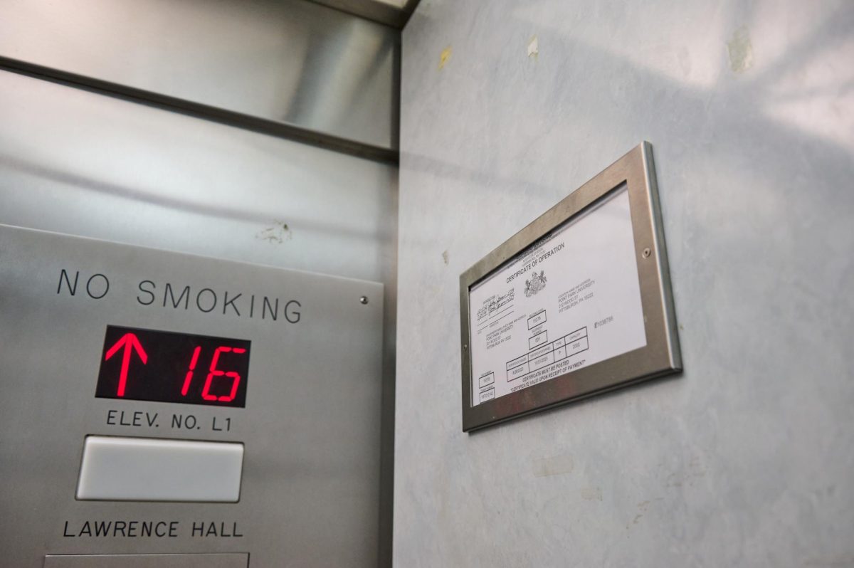 A certificate posted inside an elevator in Lawrence Hall.