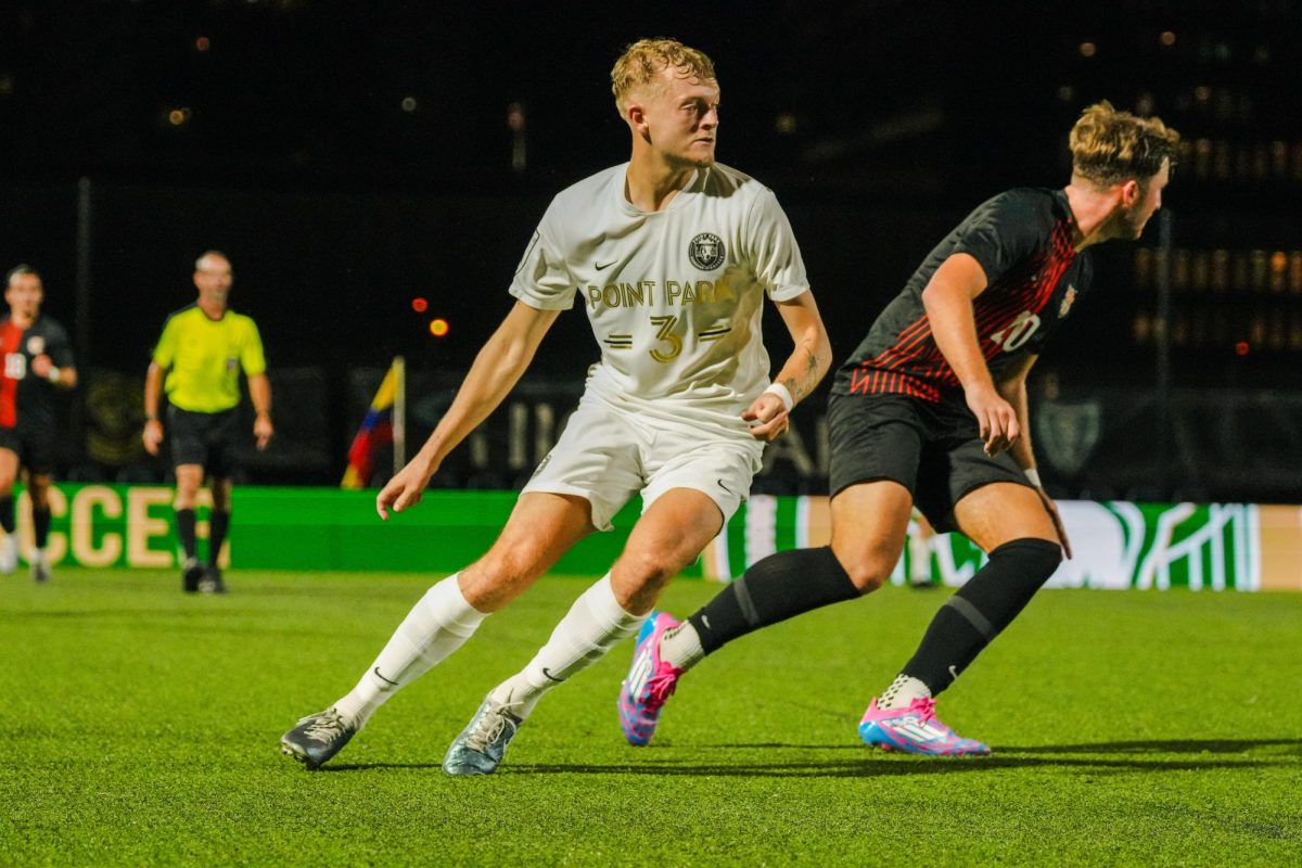 Senior Edward Bowers defends a West Virginia Wesleyan opponent on Sept. 25 at Highmark Stadium.