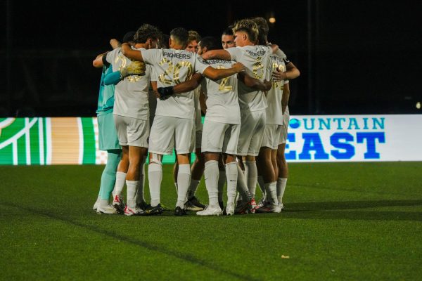 Point Park huddles before its game against West Virginia Wesleyan at Highmark Stadium in September. 