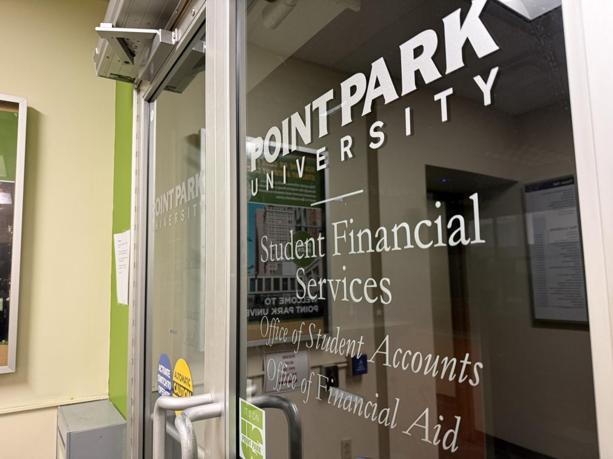 The doors that lead to the student financial services office inside floor one of Thayer Hall.